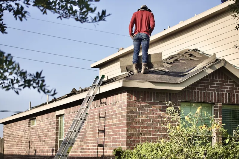 Professional roofer working on a residential roof in Upland